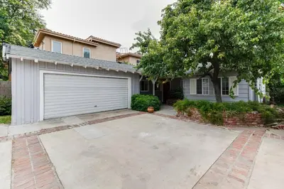 a house with a large driveway in front of a garage at Woodland Hills Zen Modern in Woodland Hills