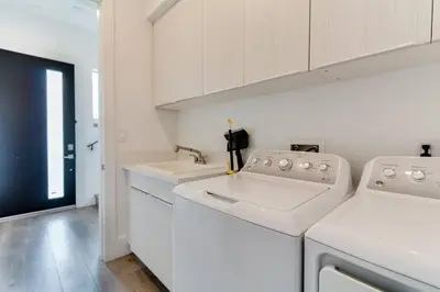 a white laundry room with a washer and dryer at Luxury Modern 4 Bedroom 3 Bathroom Home with Rooftop Deck #2 in Los Angeles