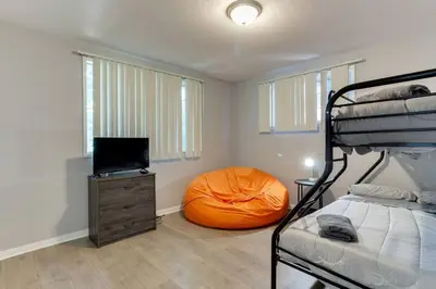 a bedroom with a bunk bed and a orange pillow at Woodland Hills Charmer in Los Angeles