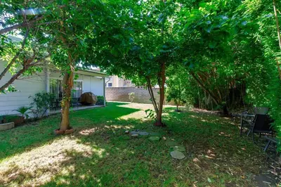 a yard with two trees and a house at Woodland Hills Charmer in Los Angeles