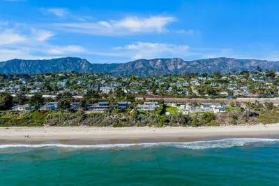 an aerial view of a beach with houses and mountains at Golden Getaway in Summerland
