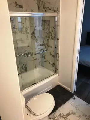 a bathroom with a toilet and a glass shower at 5 bedroom 3 bath home near universal in Sherman Oaks