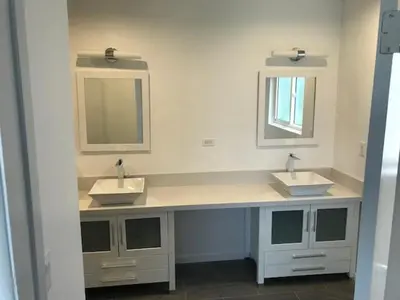 a bathroom with two sinks and two mirrors at 5 bedroom 3 bath home near universal in Sherman Oaks