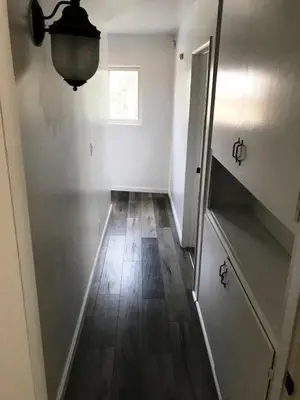 an empty room with a hallway with a wooden floor at 5 bedroom 3 bath home near universal in Sherman Oaks