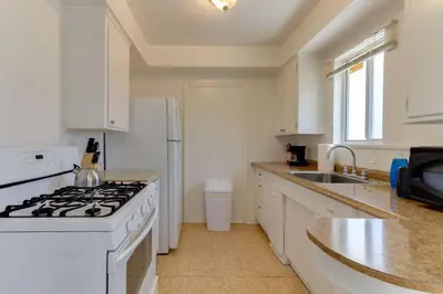 a white kitchen with a stove and a sink at 2 Bedroom Mid-Wilshire Charmer close to Downtown in Los Angeles