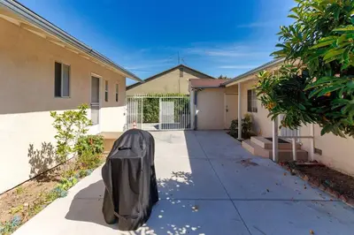 a costume is sitting on the sidewalk in front of a house at 2 Bedroom Mid-Wilshire Charmer close to Downtown in Los Angeles