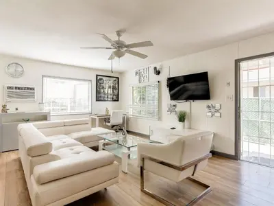 a living room with white furniture and a ceiling fan at 3 bedroom Mid-Wilshire Charmer near Downtown in Los Angeles