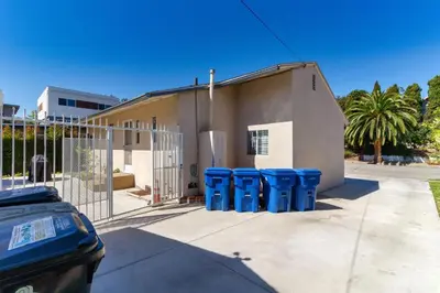 a group of blue trash cans in front of a building at 3 bedroom Mid-Wilshire Charmer near Downtown in Los Angeles