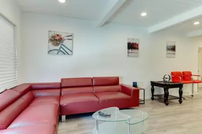 a red couch in a living room with red chairs at Large 5 bedroom charmer wIth pool in Los Angeles