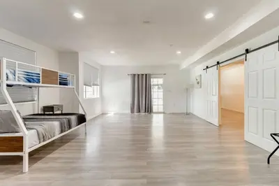 a bedroom with a bunk bed and a wooden floor at Large 5 bedroom charmer wIth pool in Los Angeles