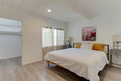 a white bedroom with a bed and a window at Large 5 bedroom charmer wIth pool in Los Angeles
