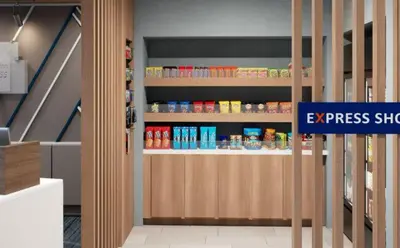 a store with an eggpressed shop sign in a room at Holiday Inn Express & Suites Hawaiian Gardens by IHG in Hawaiian Gardens