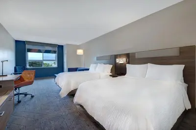 a hotel room with two beds and a desk at Holiday Inn Express & Suites Ontario - Chino Hills by IHG in Chino Hills