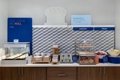 a bakery counter with donuts and other items on it at Holiday Inn Express & Suites Ontario - Chino Hills by IHG in Chino Hills