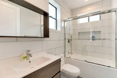 a bathroom with a sink and a toilet and a tub at 3 Luxury Modern Homes 12 bedrooms & Rooftop Decks in Los Angeles