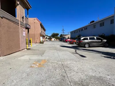 a street with cars parked in a parking lot at BELL RESORT MOTEL in Bell