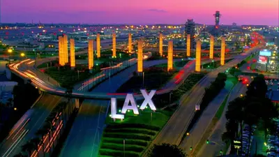 a freeway with a lit up lax sign at night at Hollywood Purple Habitat in Los Angeles