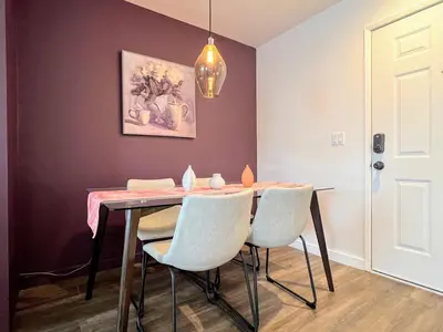a dining room with a table and white chairs at Hollywood Purple Habitat in Los Angeles