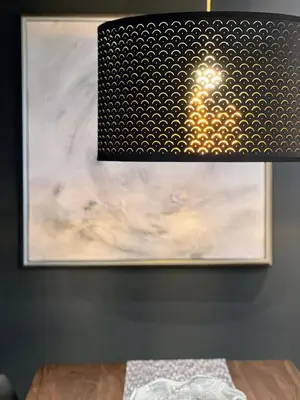 a painting on a wall next to a wooden table at Hollywood Black Habitat in Los Angeles
