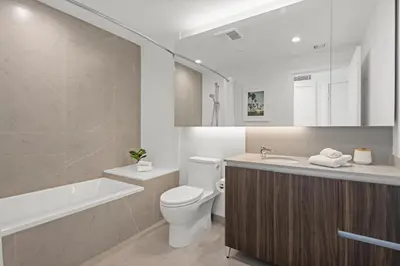 a bathroom with a toilet and a tub and a sink at Level Los Angeles - Downtown Flower in Los Angeles