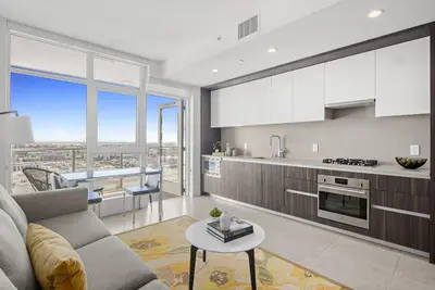 a kitchen and living room with a couch and a table at Level Los Angeles - Downtown Flower in Los Angeles