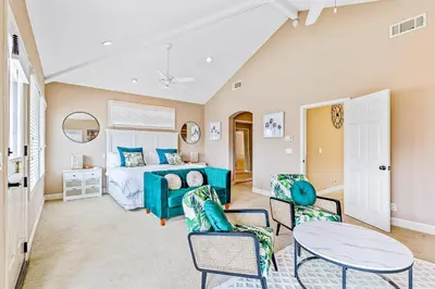 a bedroom with a bed and a table and chairs at Rivo of Dreams in Long Beach