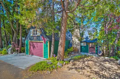 a house with a garage and a shed at Vintage Lake Arrowhead Cabin - Walk to Lake! in Lake Arrowhead