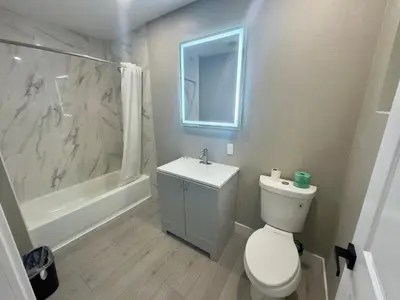 a bathroom with a toilet and a sink and a shower at Keystone Motel in Norwalk