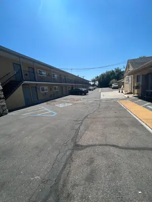 an empty parking lot in front of a building at Keystone Motel in Norwalk