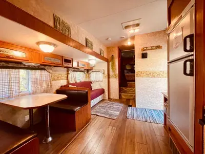 a kitchen and living room in a rv at Vintage RV Creekside Nature Retreat near Ojai next to Swim Holes Hike in Santa Paula