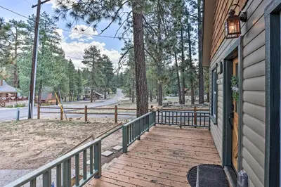 a wooden walkway leading to a door on a house at Walk to Big Bear Lake Cozy Cabin with Deck in Big Bear Lake