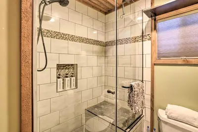 a bathroom with a shower with a glass door at Walk to Big Bear Lake Cozy Cabin with Deck in Big Bear Lake