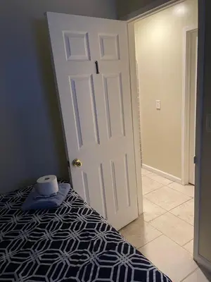 a bedroom with a bed and a white door at Sky Fresh Home Stay in Apple Valley