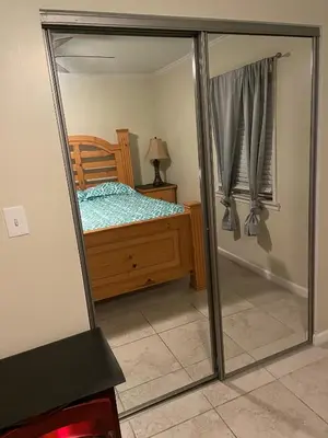 a mirror reflection of a bedroom with a bed at Sky Fresh Home Stay in Apple Valley