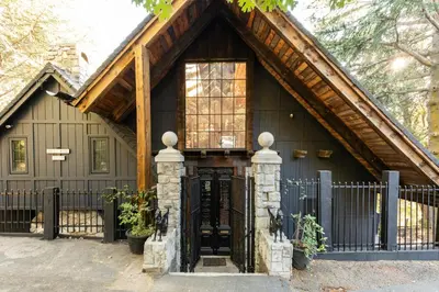 a black house with a wooden roof at 100 Mile View-Fire Pit, Romantic, Peaceful, Private in Crestline