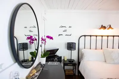 a bedroom with a bed and a mirror at 100 Mile View-Fire Pit, Romantic, Peaceful, Private in Crestline