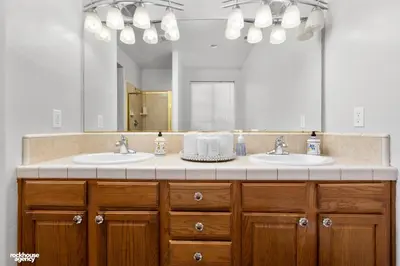 a bathroom with two sinks and a large mirror at NorthWest Farmhouse in Bakersfield