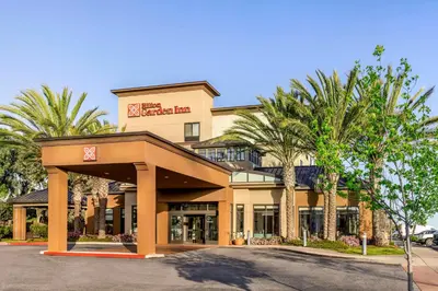 a hotel with palm trees in front of it at Hilton Garden Inn Los Angeles/Redondo Beach in Redondo Beach