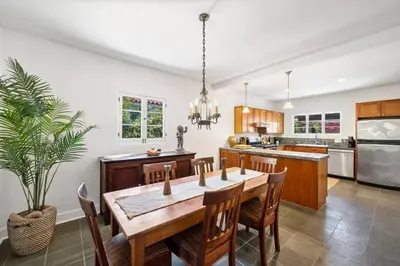 a kitchen with a wooden table and chairs and a dining room at Secluded 4BR Spanish Oasis in the Heart of LA in Los Angeles