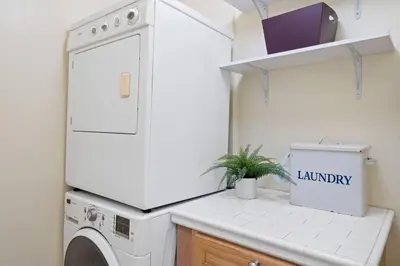 a laundry room with a washing machine and a plant at Secluded 4BR Spanish Oasis in the Heart of LA in Los Angeles