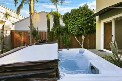 a hot tub in the backyard of a house at Beach Villa * Hot Tub * Steps to Beach in Long Beach