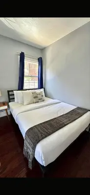 two large beds in a room with a window at Hollywood house with parking - walk to attractions in Los Angeles