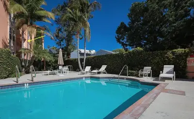 a swimming pool with chairs and umbrellas at The Best Santa Monica Beach Area, Any days,Newly Remodeled in Los Angeles