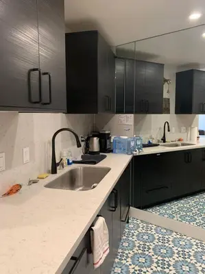 a kitchen with a sink and black cabinets at The Best Santa Monica Beach Area, Any days,Newly Remodeled in Los Angeles