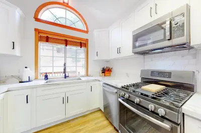 a kitchen with white cabinets and a stove top oven at Sequoia Serenity in Lake Arrowhead