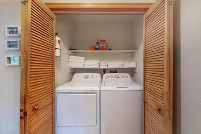 a small laundry room with a white washer and dryer at Sequoia Serenity in Lake Arrowhead