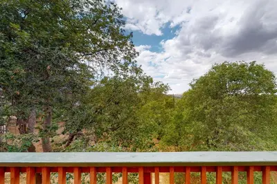 a red fence with trees in the background at Sequoia Serenity in Lake Arrowhead