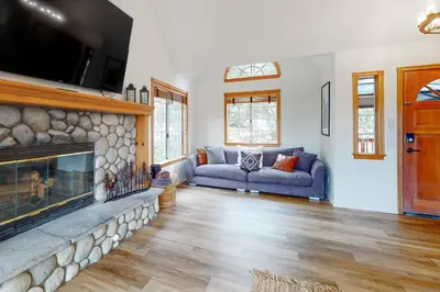 a living room with a couch and a fireplace at Sequoia Serenity in Lake Arrowhead