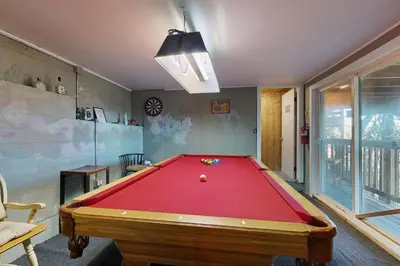 a billiard room with a red pool table at Lakeside Serenity in Crestline