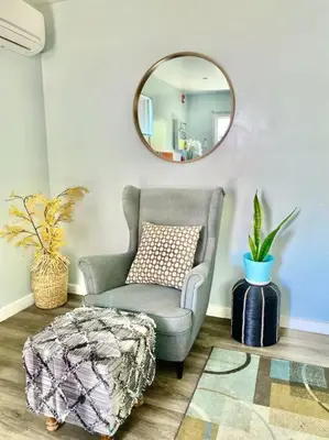 a living room with a chair and a mirror at Hidden Gem LA 2bd house with dreamy backyard in Encino